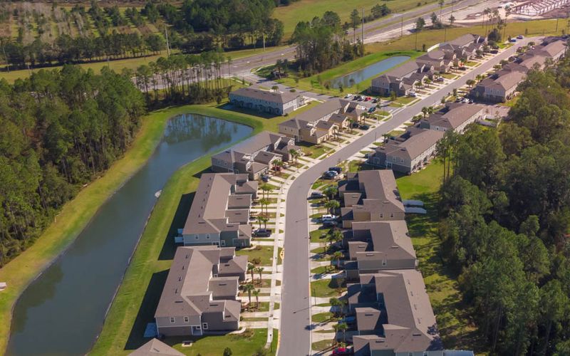 Aerial view of a neighborhood along a pond