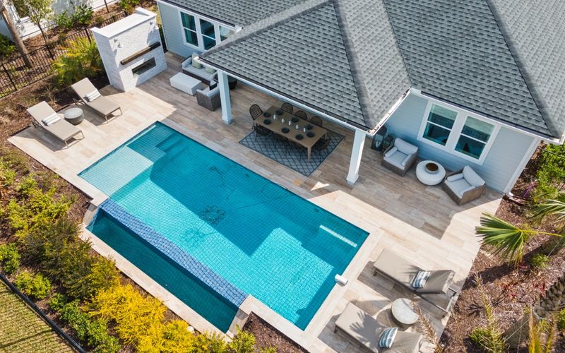 Aerial drone photo of a home with a pool