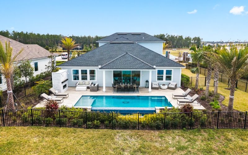 Drone view of a home and backyard pool